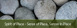 picture of smooth grey round river stones - with text reading sense of place/senses of place