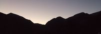 picture of sunset on the Rocky Mountains, mountains silhouetted with rose-colored sky, M. Hauk photographer
